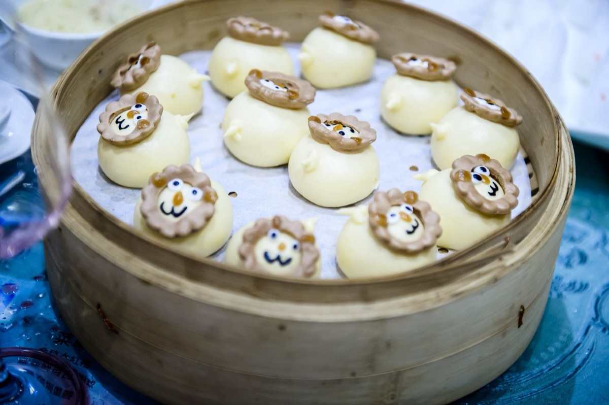 A dim sum platter with steam rising in a Hong Kong market