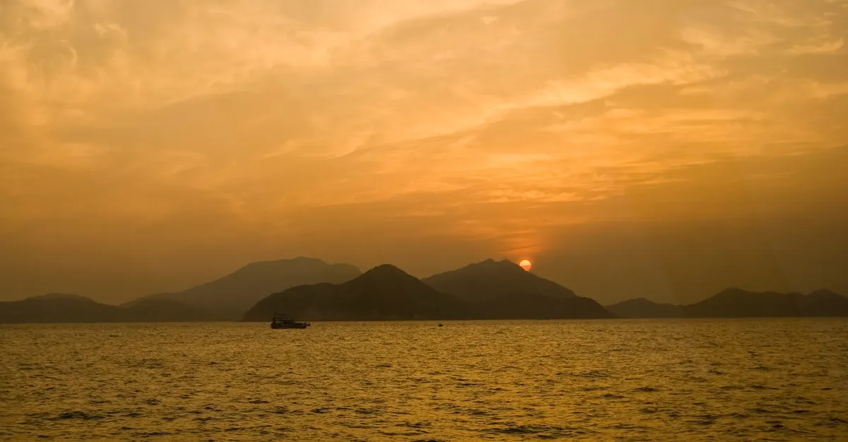 Beautiful sunset view over the waters of Lantau, Hong Kong, with serene island silhouettes.